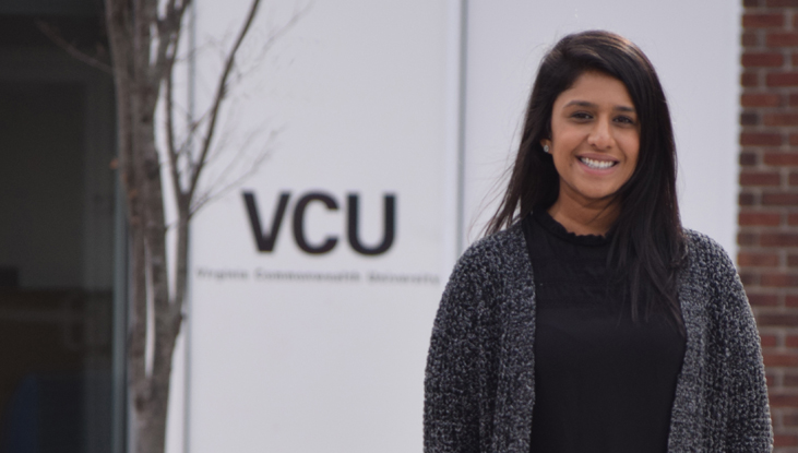 Kripali Patel, Pharm.D. smiling in front of a VCU sign